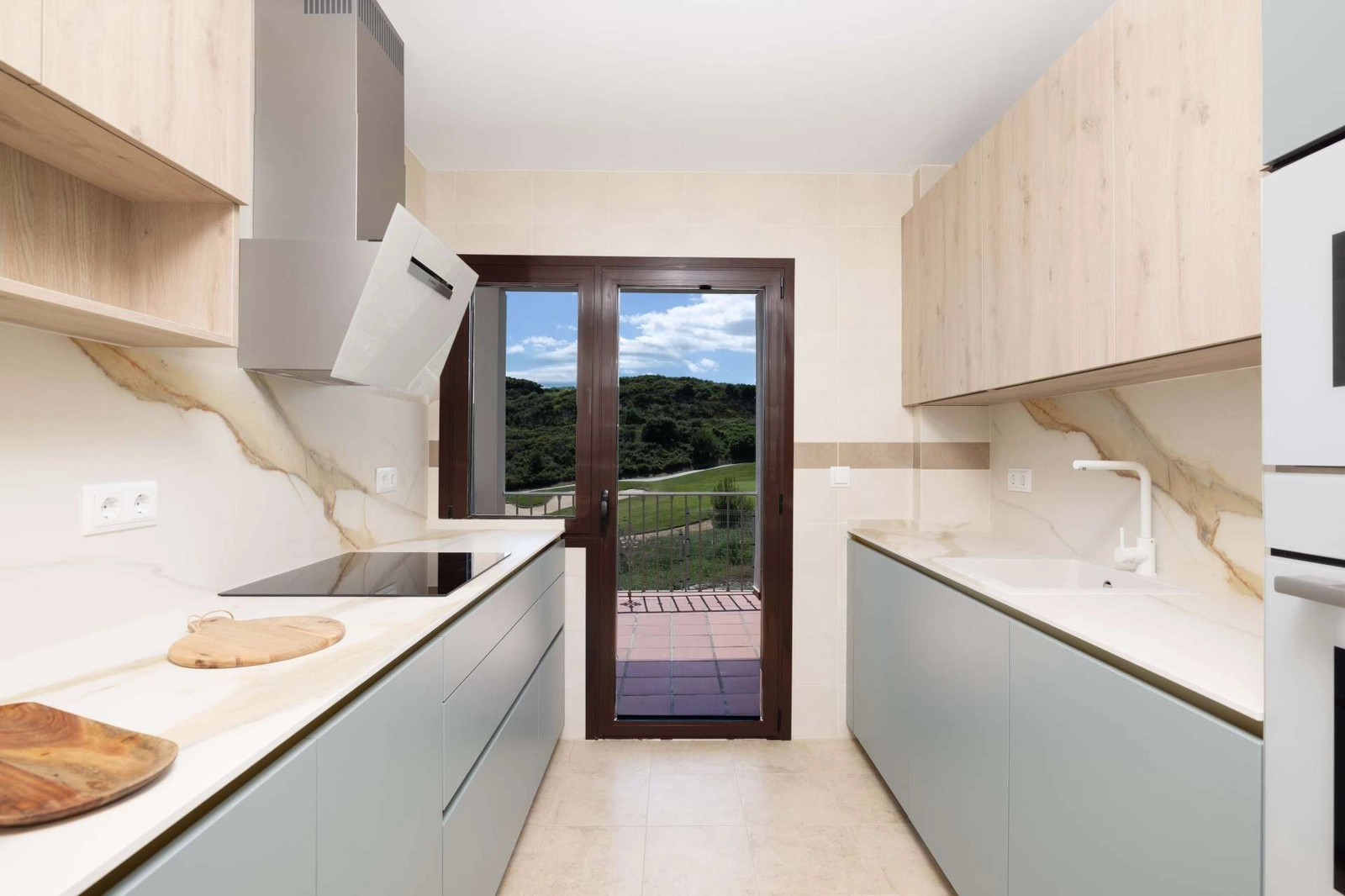 La cocina moderna está diseñada para la funcionalidad y el estilo, con vistas al exterior.