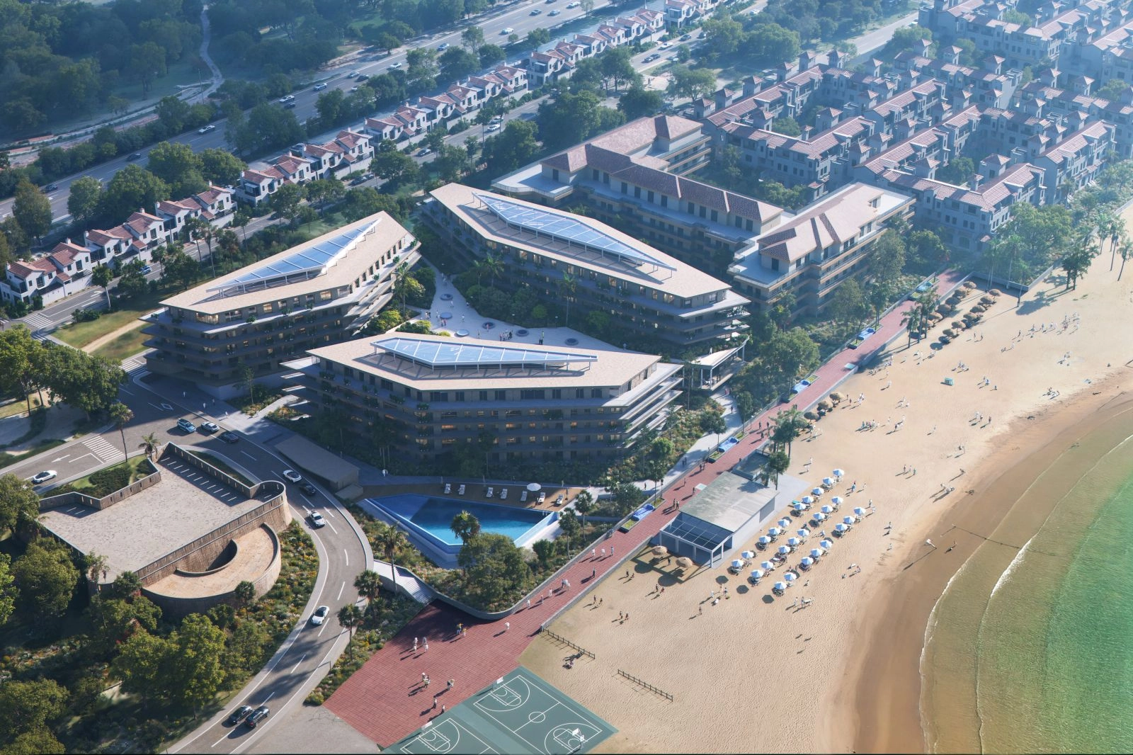 Una perspectiva aérea que muestra la excelente ubicación en primera línea de playa y la arquitectura moderna de la promoción.
