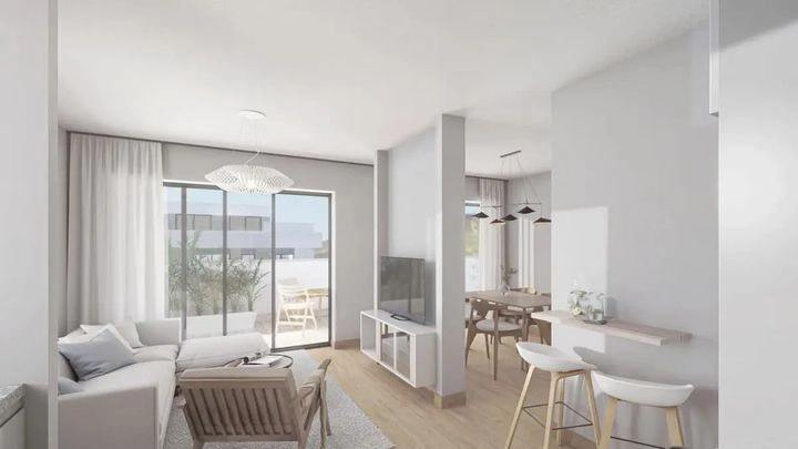Una vista del salón, conectado de forma fluida con el espacio de la terraza exterior.