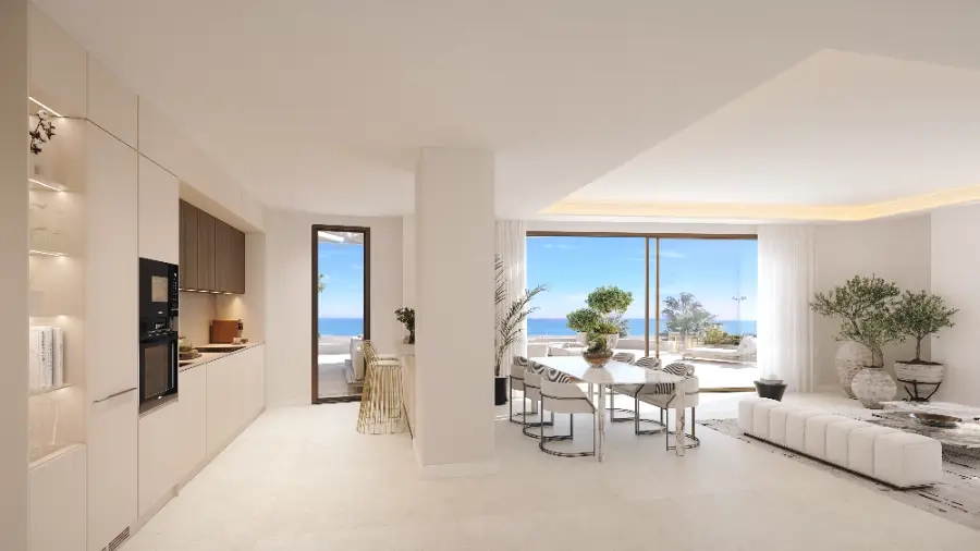 Una cocina de planta abierta y zona de comedor en un ático, diseñada para un entretenimiento sin esfuerzo con vistas al mar.