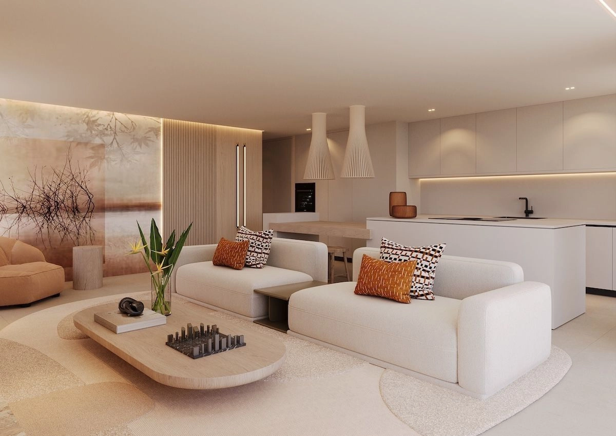 Una cocina moderna y elegante equipada con electrodomésticos de alta gama, perfectamente integrada en las zonas de estar y comedor.