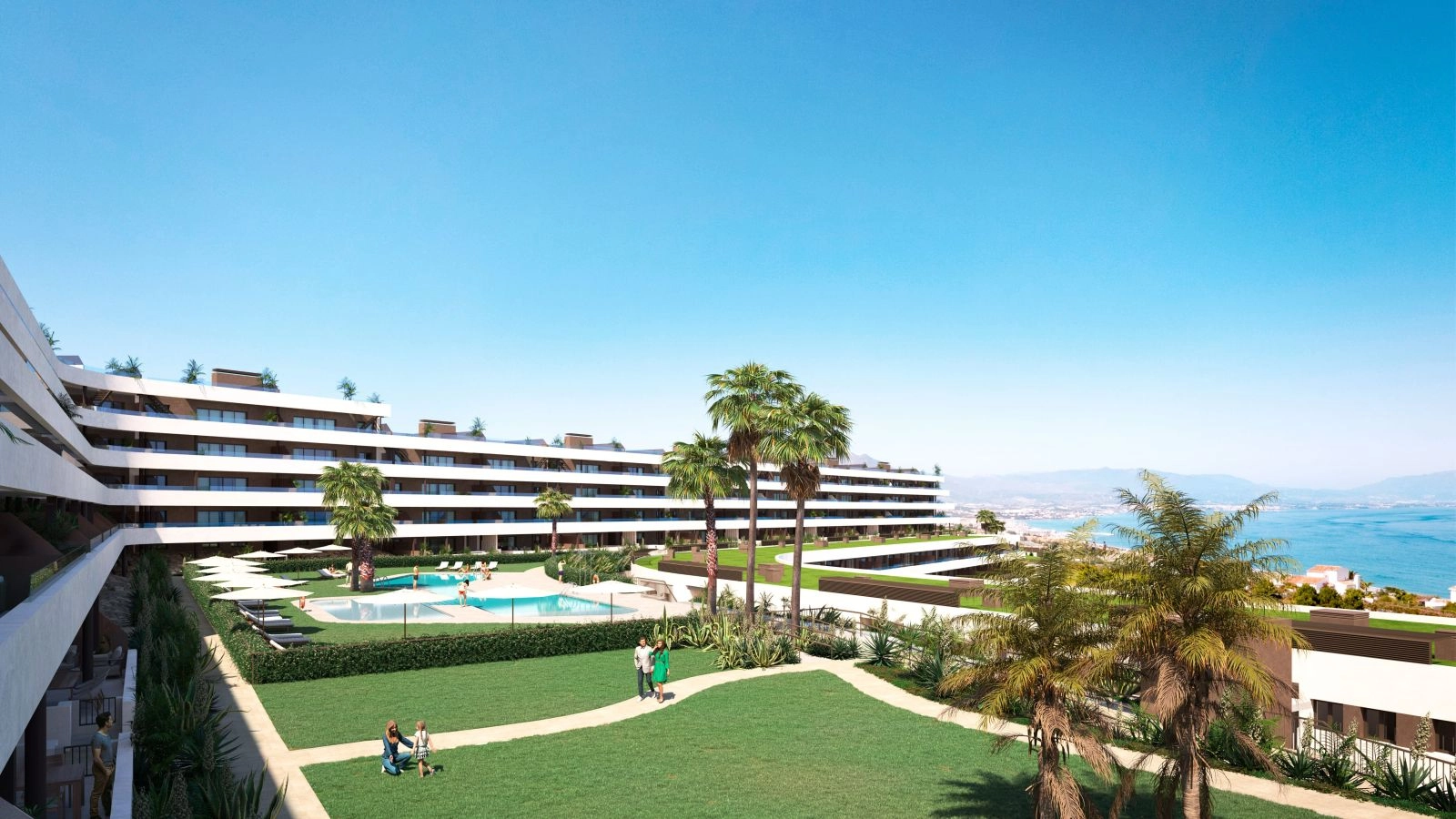 Vista de los hermosos jardines comunitarios y la piscina con el mar Mediterráneo de fondo.