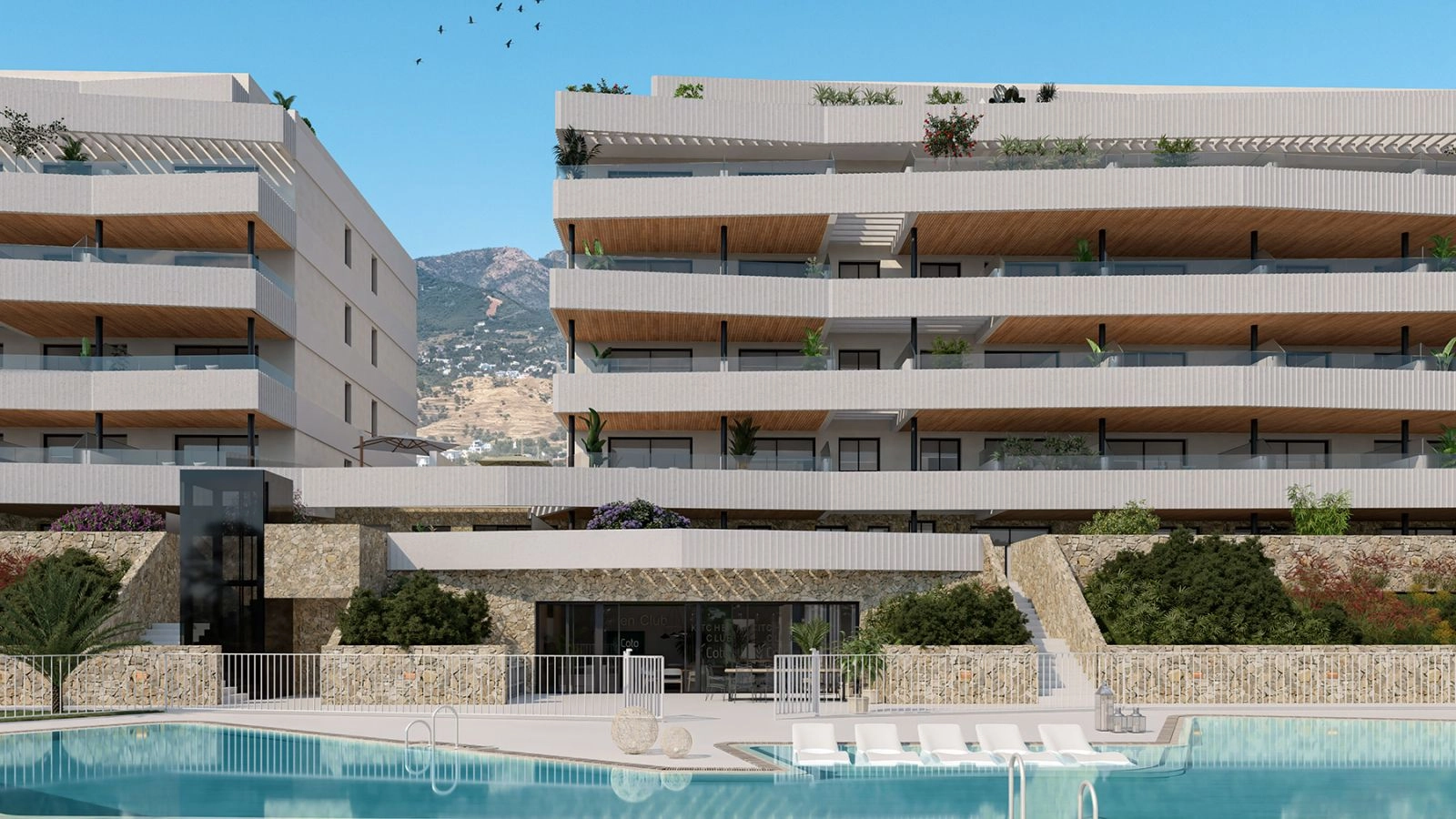 Un vistazo más de cerca a los detalles arquitectónicos contemporáneos y los hermosos niveles inferiores revestidos de piedra junto a la piscina.