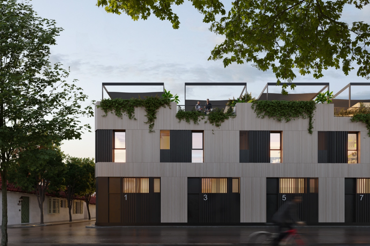 Una vista nocturna de la urbanización, que muestra su cálida iluminación y elegante arquitectura.