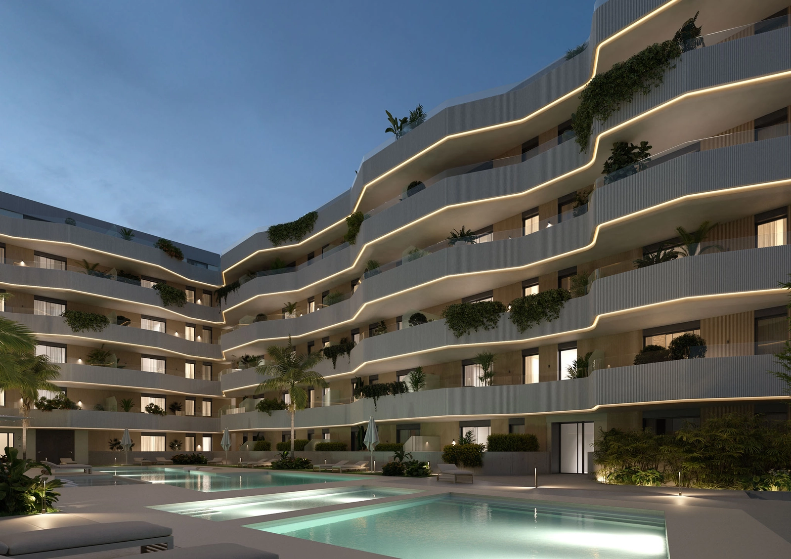 La piscina y los jardines comunitarios bellamente iluminados por la noche, creando una atmósfera mágica.