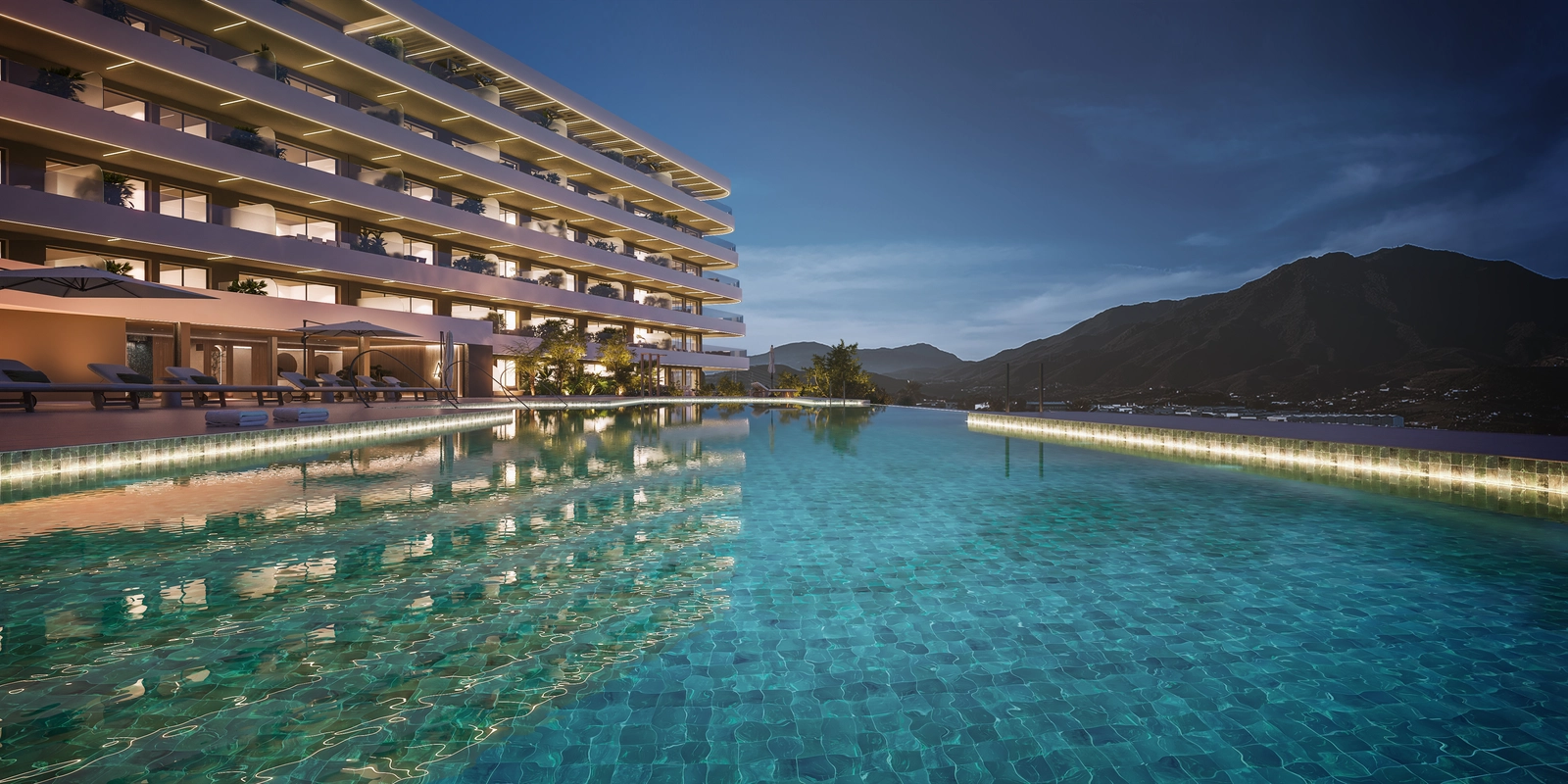 La zona de la piscina infinita comunitaria al atardecer, que ofrece un espacio tranquilo para nadar y relajarse mientras se disfrutan las vistas a la montaña.