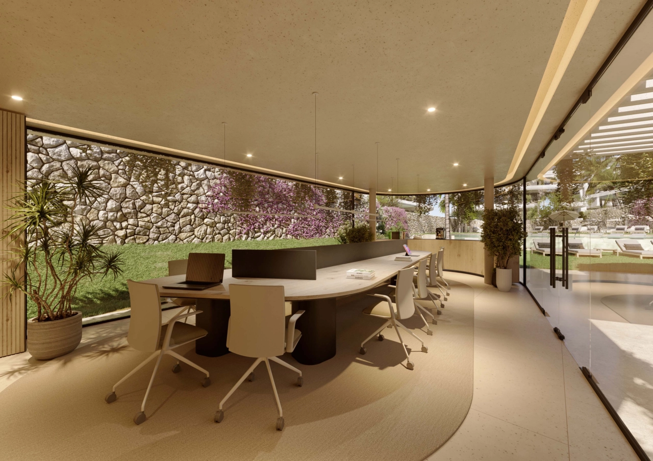 Un sereno espacio de co-working con vistas al jardín, que proporciona un ambiente cómodo e inspirador para trabajar o celebrar reuniones.